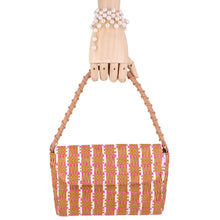 Load image into Gallery viewer, hand wearing a pearl bracelet holding a woven italian bag
